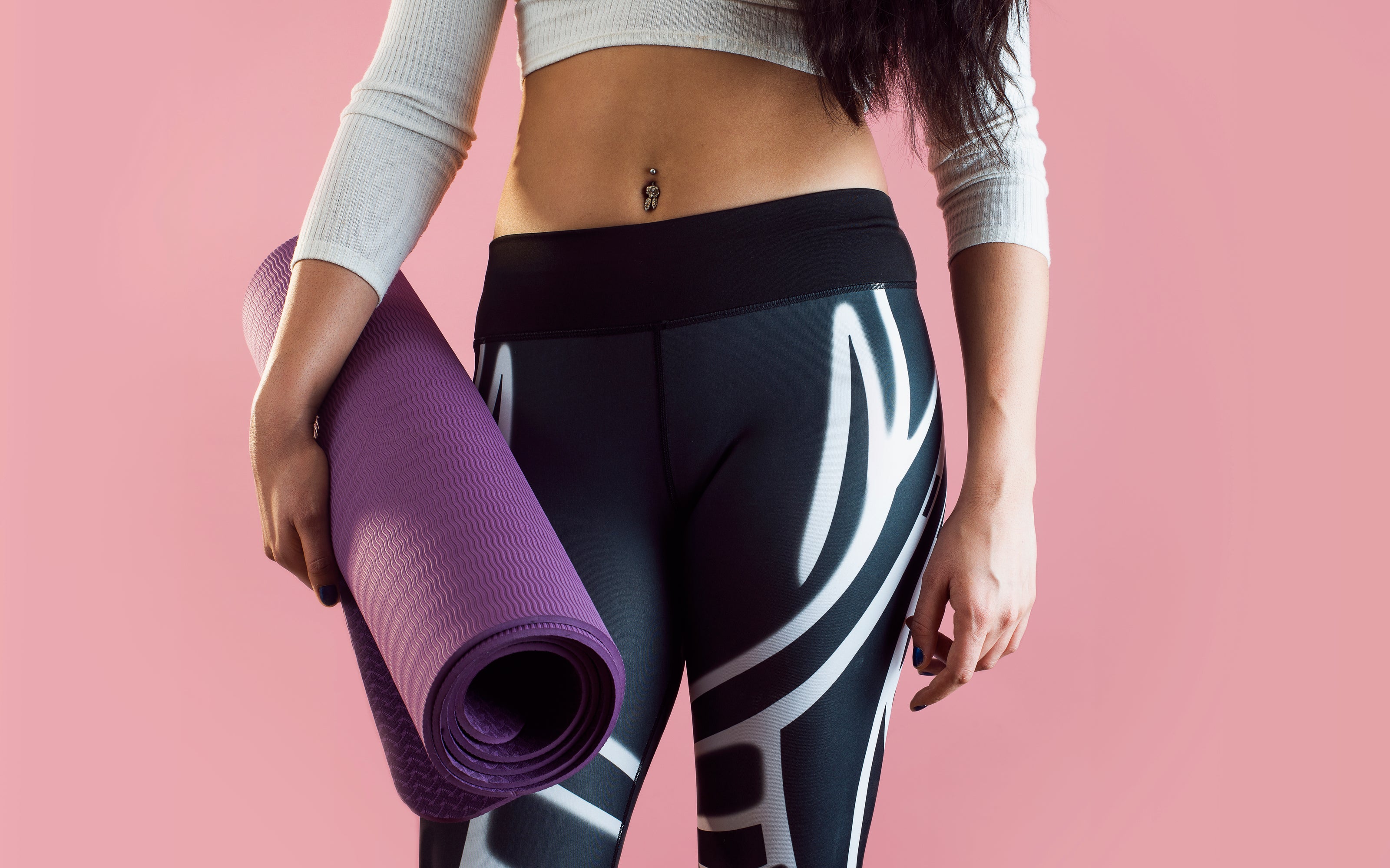 female yoga fashion with folding yoga mat